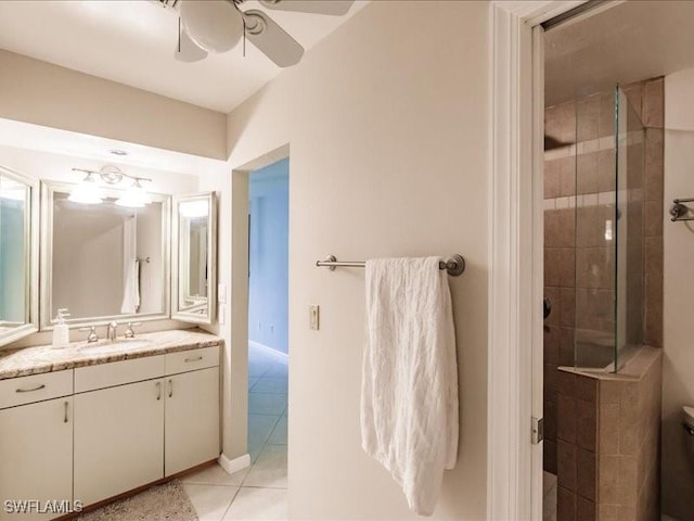 bathroom with a tile shower, vanity, tile patterned floors, and ceiling fan