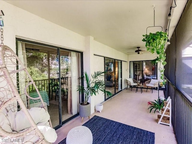 sunroom / solarium featuring ceiling fan