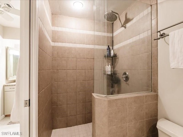 bathroom featuring a tile shower and toilet