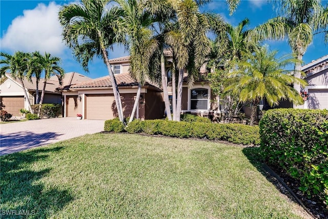 view of front of property with a front yard and a garage