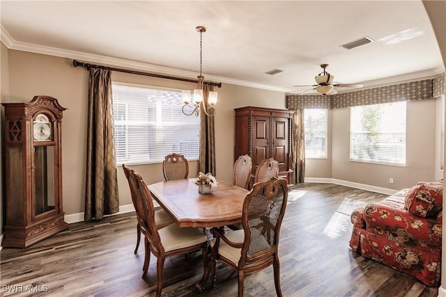 dining space featuring crown molding, dark wood-type flooring, and ceiling fan with notable chandelier