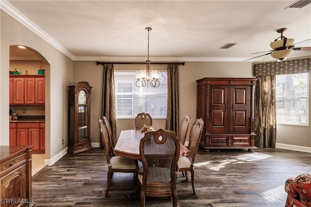 dining area with ceiling fan with notable chandelier, crown molding, and dark wood-type flooring