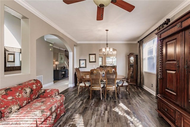 dining room featuring ceiling fan with notable chandelier, dark hardwood / wood-style floors, and ornamental molding