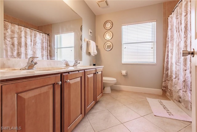 bathroom featuring toilet, vanity, and tile patterned floors