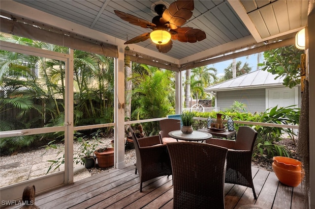 sunroom featuring ceiling fan and wooden ceiling