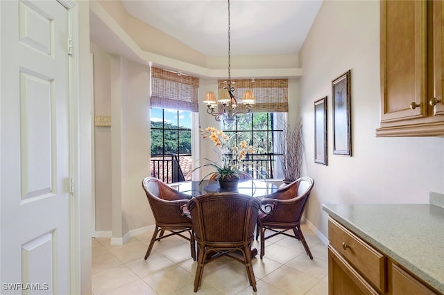 dining area featuring a chandelier and light tile patterned flooring