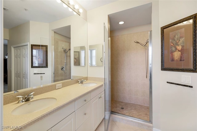 bathroom featuring vanity, tile patterned floors, and a shower with door