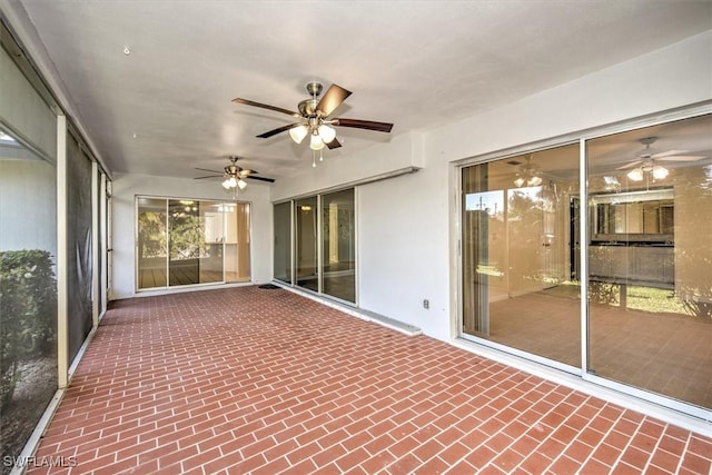 unfurnished sunroom featuring ceiling fan