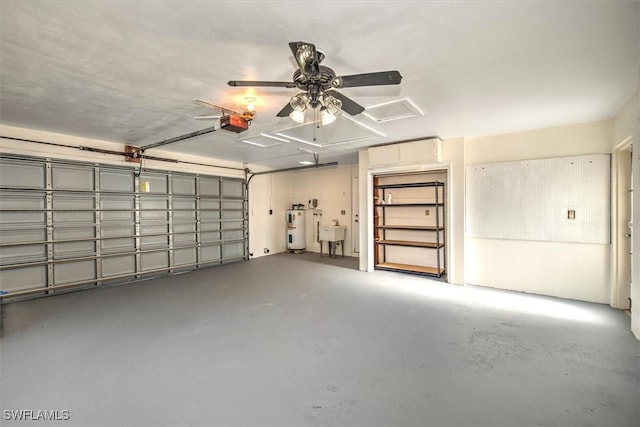 garage featuring water heater, sink, ceiling fan, and a garage door opener