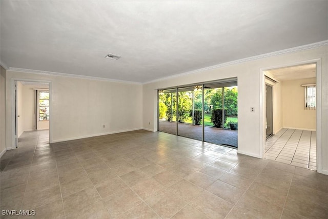 tiled spare room featuring crown molding