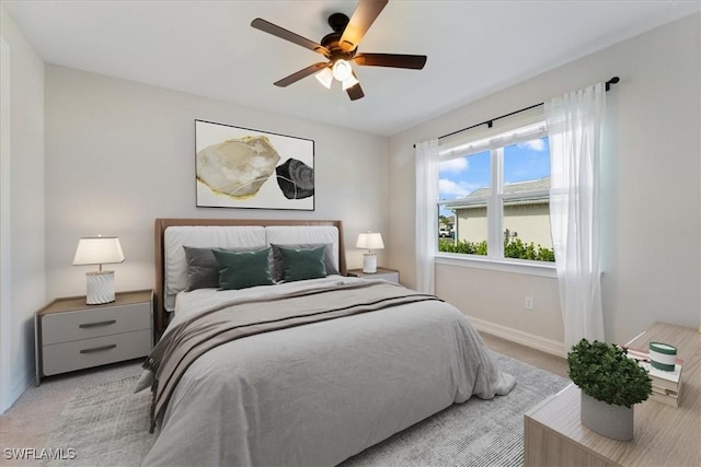 bedroom with ceiling fan and light colored carpet