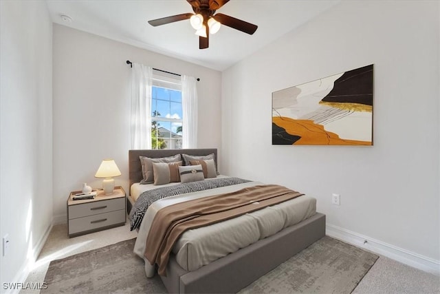 bedroom with ceiling fan and light carpet