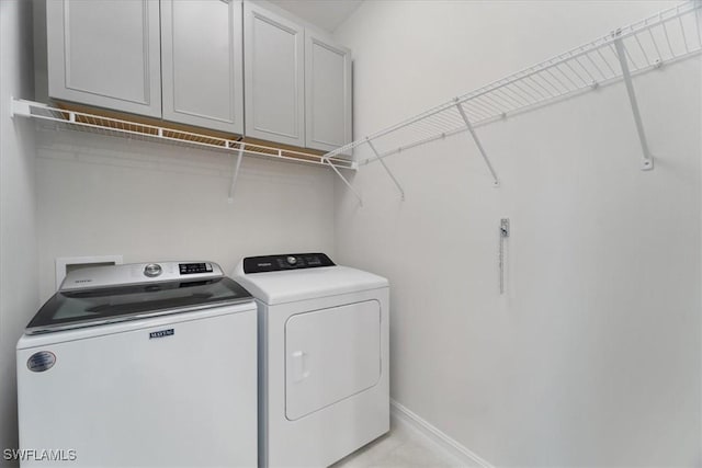 laundry area with cabinets and washer and dryer