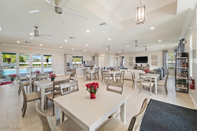 tiled dining area with ceiling fan, plenty of natural light, french doors, and ornamental molding