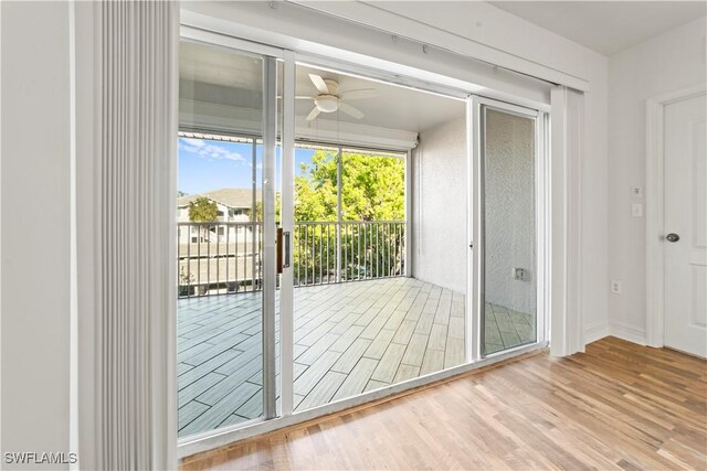 doorway to outside featuring ceiling fan and wood-type flooring