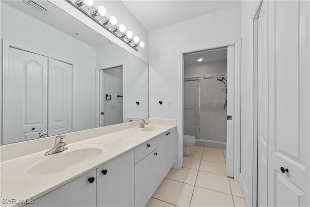 bathroom with tile patterned flooring, vanity, toilet, and walk in shower