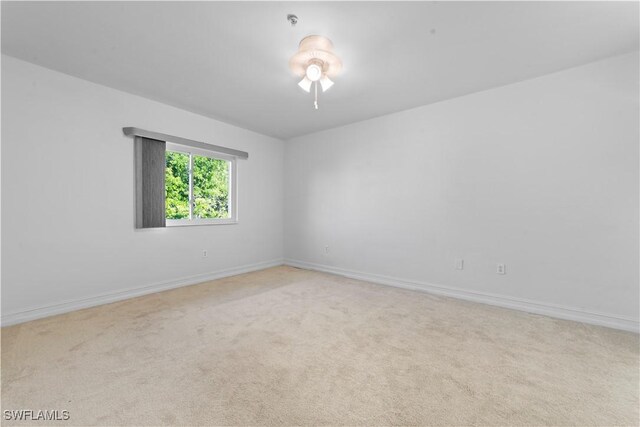 spare room with light colored carpet