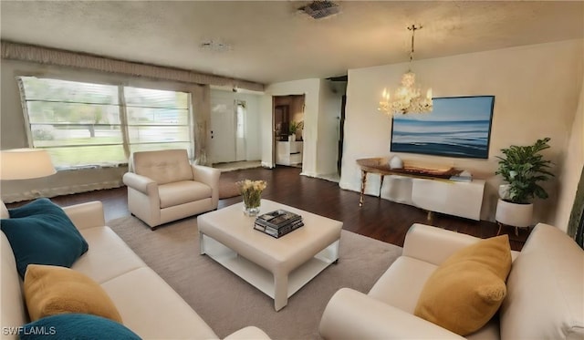 living room featuring hardwood / wood-style flooring and an inviting chandelier