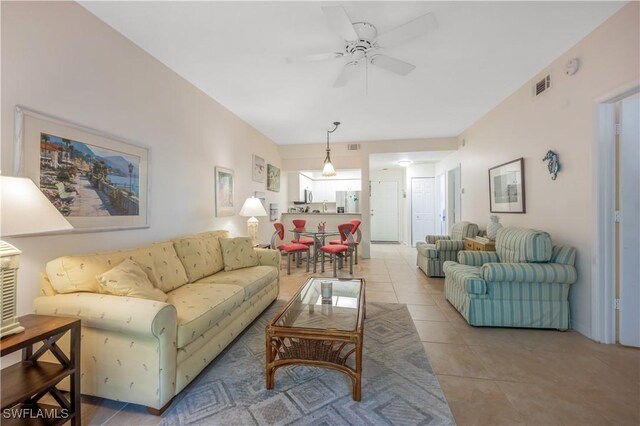 tiled living room featuring ceiling fan