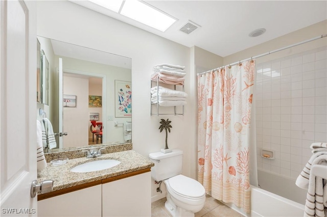 full bathroom with shower / tub combo, a skylight, vanity, tile patterned flooring, and toilet