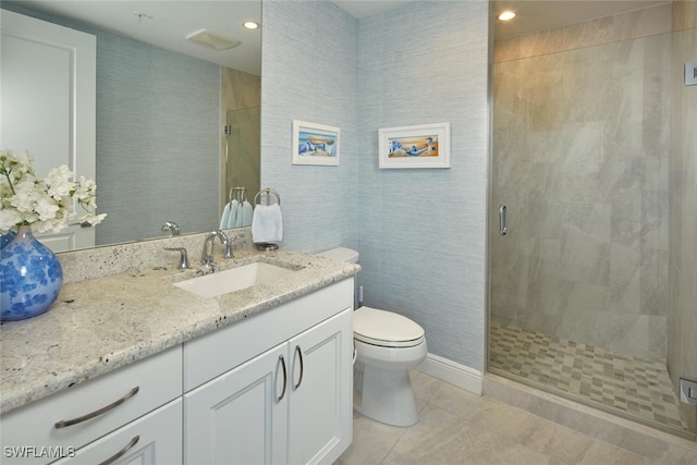 bathroom featuring tile patterned floors, vanity, toilet, and walk in shower