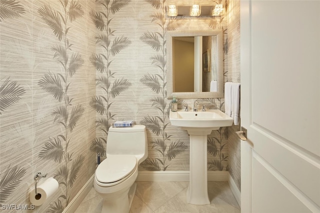 bathroom featuring tile patterned floors, toilet, and sink