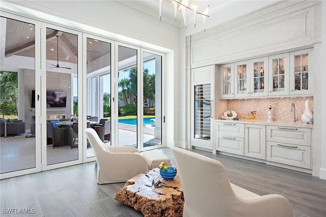 interior space featuring hardwood / wood-style floors, beamed ceiling, and an inviting chandelier