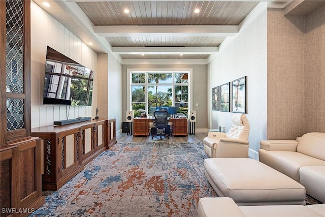 office area with beam ceiling, light wood-type flooring, and a healthy amount of sunlight