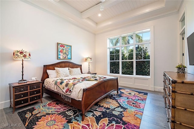 bedroom with beamed ceiling, hardwood / wood-style flooring, and wooden ceiling