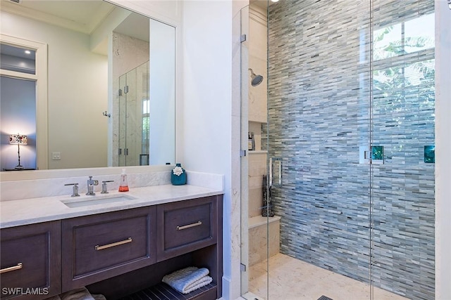 bathroom with crown molding, vanity, and an enclosed shower