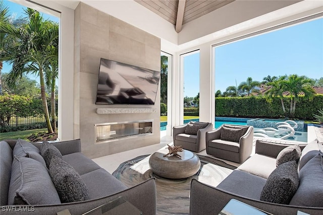 view of patio featuring an outdoor living space with a fireplace and a fenced in pool