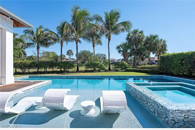 view of swimming pool with an in ground hot tub