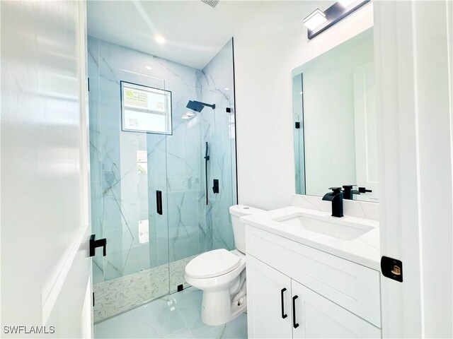 bathroom with tile patterned flooring, vanity, an enclosed shower, and toilet