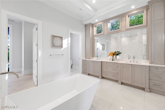 full bathroom with beam ceiling, a wealth of natural light, hardwood / wood-style floors, and vanity