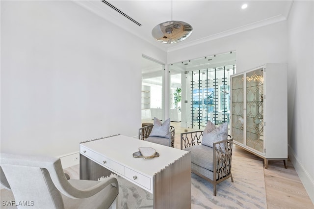 office with ornamental molding and light hardwood / wood-style flooring