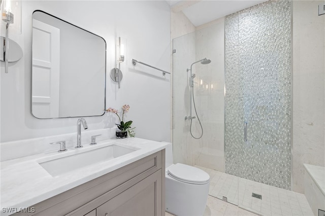 bathroom featuring tile patterned flooring, vanity, toilet, and walk in shower