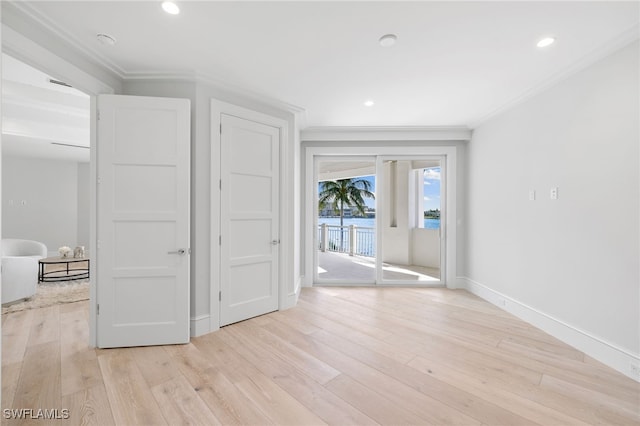 interior space featuring crown molding and light hardwood / wood-style flooring