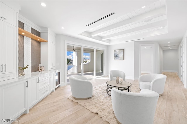 living room with beamed ceiling and light hardwood / wood-style floors