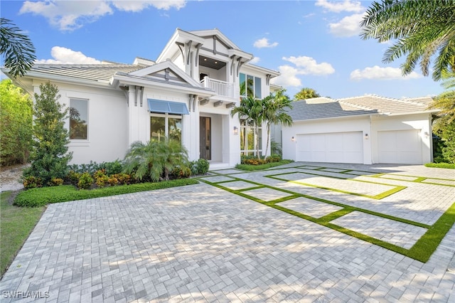 view of front of home with a garage and a balcony