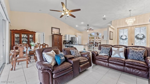 tiled living room featuring ceiling fan with notable chandelier and vaulted ceiling