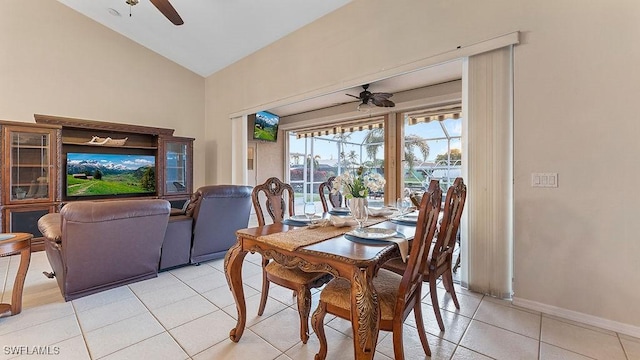 tiled dining area featuring vaulted ceiling and ceiling fan