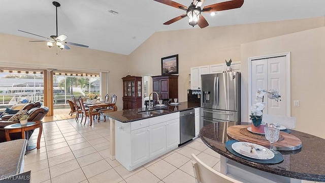 kitchen with white cabinets, light tile patterned floors, sink, and appliances with stainless steel finishes