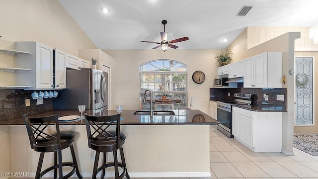 kitchen with tasteful backsplash, white cabinetry, sink, and appliances with stainless steel finishes