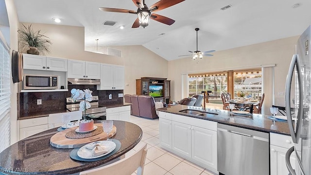 kitchen with white cabinets, sink, tasteful backsplash, light tile patterned flooring, and stainless steel appliances