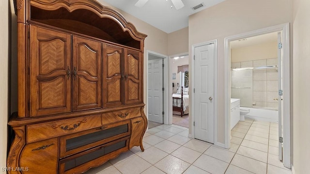 interior space featuring combined bath / shower with glass door, tile patterned floors, and ceiling fan