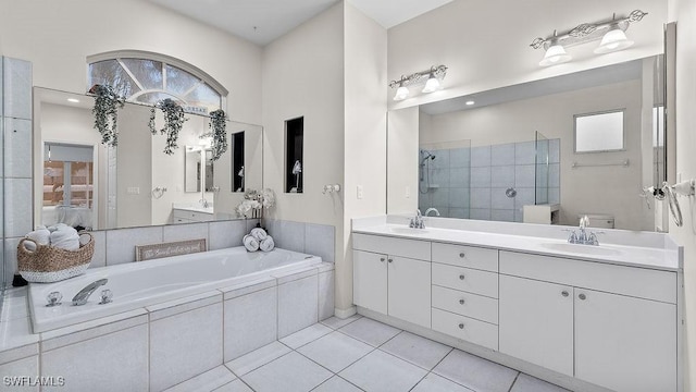 full bathroom with toilet, tile patterned floors, separate shower and tub, and plenty of natural light