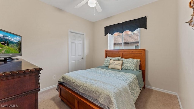 bedroom featuring ceiling fan and light colored carpet