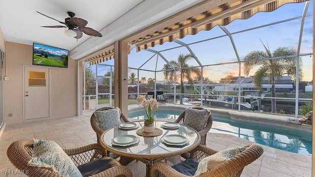 sunroom with a pool and ceiling fan