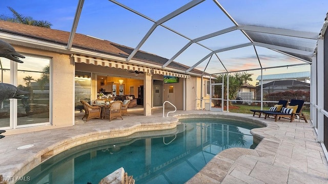 view of swimming pool featuring glass enclosure and a patio area