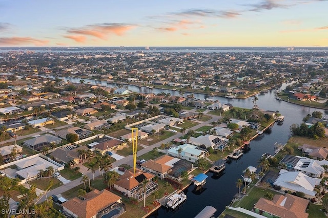 aerial view at dusk with a water view